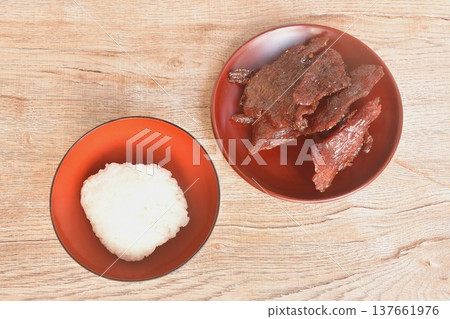 salty and sweet dry fried slice beef meat fermenting in sesame oil and pepper on plate eat couple sticky rice 137661976