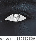 Woman peeking through broken glass eye hole covering mouth 137662309