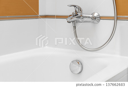 Chrome bath shower faucet and bathtub in modern bathroom Chrome bath shower faucet and bathtub in modern bathroom 137662683