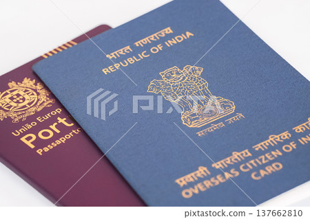 View of Overseas Citizen of India Card with Portuguese passport on white background. 137662810