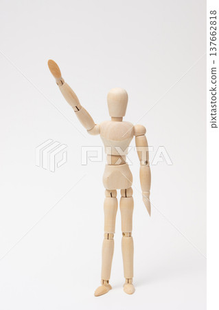 A drawing mannequin with its right hand raised. A drawing mannequin with its right hand raised. 137662818