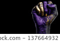 A raised fist painted in purple and gold symbolizes strength and independence. The background is black, emphasizing the powerful message of feminism and empowerment. 137664932
