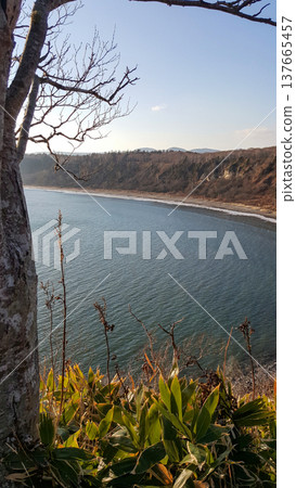 A breathtaking autumn evening at the rocky coastline of the Kuril Islands, illuminated by a stunning sunset. A breathtaking autumn evening at the rocky coastline of the Kuril Islands, illuminated by a stunning sunset. 137665457