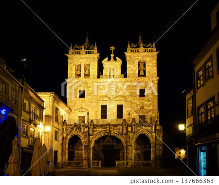 Night view of Braga Cathedral in Portugal: A historic building illuminated at night. Night view of Braga Cathedral in Portugal: A historic building illuminated at night. 137666363