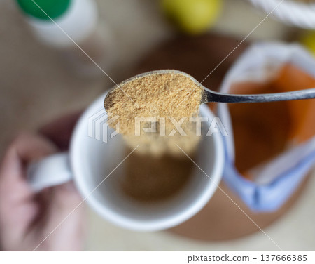 Person adding apple fiber powder to a glass of yogurt, surrounded by fresh apples and walnuts. Healthy prebiotic supplement for gut health, digestion and weight management. Person adding apple fiber powder to a glass of yogurt, surrounded by fresh apples and walnuts. Healthy prebiotic supplement for gut health, digestion and weight management. 137666385