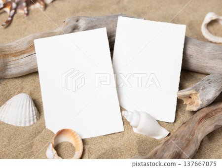 Mockup of blank cards on beige sand with seashells, template for beach wedding and event graphics 137667075