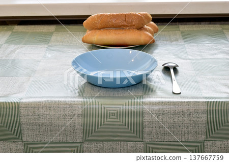 There is a blue plate on the table. There is a blue plate on the table. 137667759