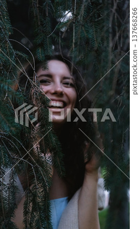 Portrait of a very beautiful young woman in a summer spruce forest at sunset. Portrait of a very beautiful young woman in a summer spruce forest at sunset. 137668266