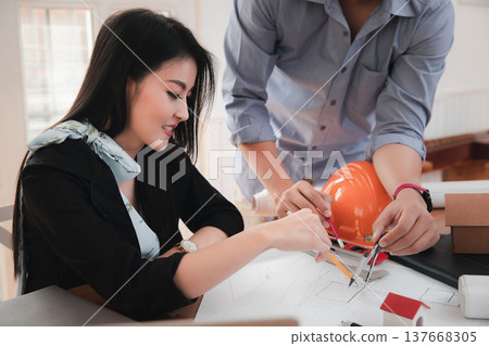 Group of two coworkers working with blueprint in office. co-working teamwork concept. Group of two coworkers working with blueprint in office. co-working teamwork concept. 137668305
