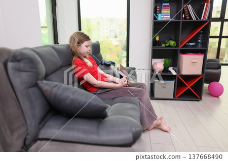 Engaging moments as a young girl explores a book in a cozy, sunlit living room during a quiet afternoon 137668490