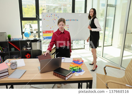 Students engaged in an interactive learning session in a bright, modern classroom while utilizing creative materials and technology 137668516