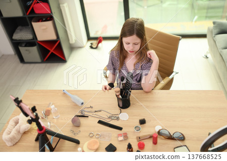Creative makeup session brings joy to a young girl experimenting with colors in a bright modern room filled with beauty tools Creative makeup session brings joy to a young girl experimenting with colors in a bright modern room filled with beauty tools 137668525