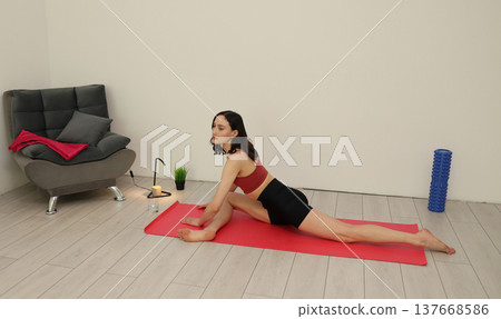 Yoga practice in a serene indoor space with a calm atmosphere and focused energy during evening hours 137668586