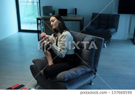 Cozy afternoon in a modern living space with a woman enjoying quiet time and creative expression Cozy afternoon in a modern living space with a woman enjoying quiet time and creative expression 137668599