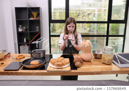Young chef explores culinary creativity in a bright kitchen while preparing delicious treats and discovering new flavors 137668649