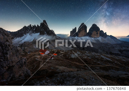 Scenic view of Milky way over Tre Cime mountain peak and mountain hut in the night at Dolomites, Italy Scenic view of Milky way over Tre Cime mountain peak and mountain hut in the night at Dolomites, Italy 137670848