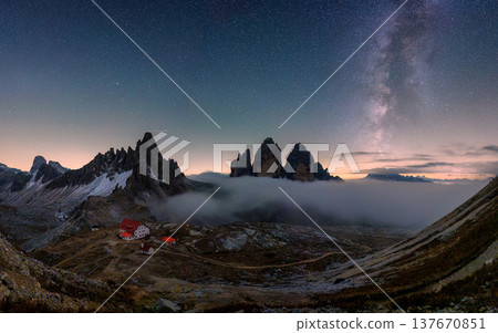 Scenic view of Milky Way over Tre Cime di Lavaredo mountain and Rifugio Locatelli at night in Dolomites, Italy 137670851
