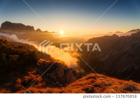 Golden sunrise over rocky mountain peak in Cadini di Misurina at Dolomites, Italy Golden sunrise over rocky mountain peak in Cadini di Misurina at Dolomites, Italy 137670858