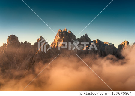 Sunrise shining on Cadini di Misurina peaks and foggy in Dolomites, Italy Sunrise shining on Cadini di Misurina peaks and foggy in Dolomites, Italy 137670864