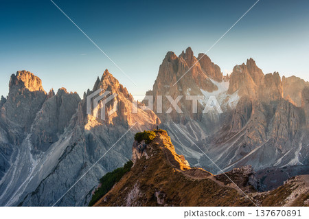 Alpine landscape of Cadini di Misurina with rugged mountain range during sunset in Dolomites, Italy Alpine landscape of Cadini di Misurina with rugged mountain range during sunset in Dolomites, Italy 137670891