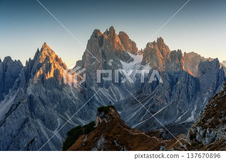 Alpine landscape of Cadini di Misurina with rugged mountain range during sunset in Dolomites, Italy Alpine landscape of Cadini di Misurina with rugged mountain range during sunset in Dolomites, Italy 137670896