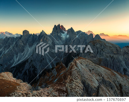 Alpine landscape of Cadini di Misurina with rugged mountain range during sunset in Dolomites, Italy Alpine landscape of Cadini di Misurina with rugged mountain range during sunset in Dolomites, Italy 137670897