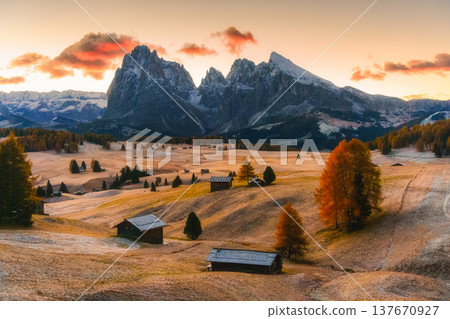 Scenic view of Alpe di Siusi with autumn rolling hill and rustic huts during morning in Dolomites, Italy Scenic view of Alpe di Siusi with autumn rolling hill and rustic huts during morning in Dolomites, Italy 137670927