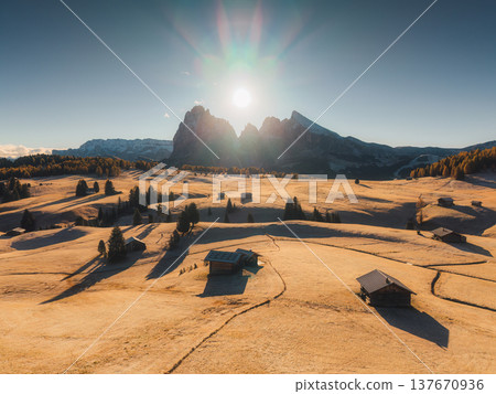 Scenic view of Alpe di Siusi with autumn rolling hill and rustic huts during morning in Dolomites, Italy 137670936