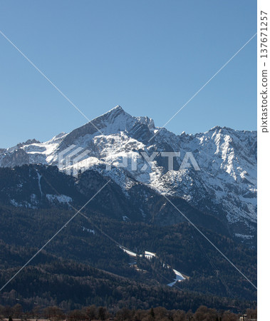 Vertical alpine mountain view with snowy peaks in Bavaria Germany Vertical alpine mountain view with snowy peaks in Bavaria Germany 137671257