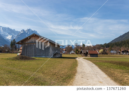 Rural barn and path with Alpine mountains in Bavaria Germany Rural barn and path with Alpine mountains in Bavaria Germany 137671260