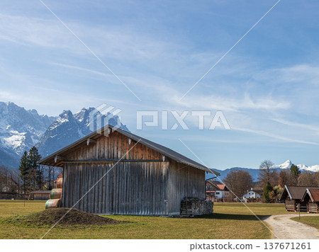 Rural barn and path with Alpine mountains in Bavaria Germany Rural barn and path with Alpine mountains in Bavaria Germany 137671261