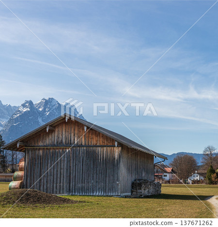 Rural barn and path with Alpine mountains in Bavaria Germany Rural barn and path with Alpine mountains in Bavaria Germany 137671262