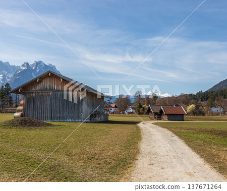 Bavarian rural barn and winding path in Alpine countryside Bavarian rural barn and winding path in Alpine countryside 137671264