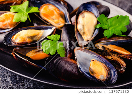 Delicious seafood mussels with sauce and parsley. Delicious seafood mussels with sauce and parsley. 137671380