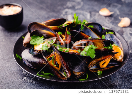 Delicious seafood mussels with sauce and parsley. Delicious seafood mussels with sauce and parsley. 137671381