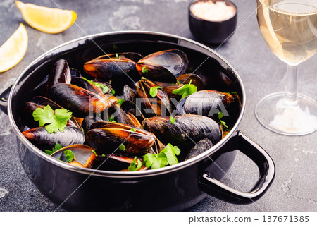 Delicious seafood mussels with sauce and parsley. Delicious seafood mussels with sauce and parsley. 137671385