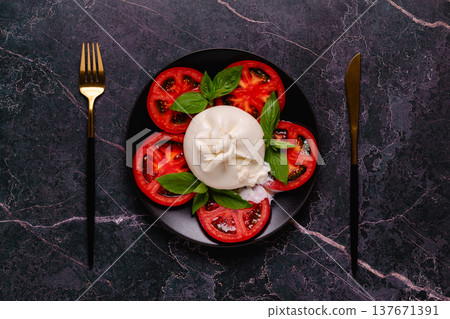 Caprese salad with tomatoes, burrata cheese and basil. Caprese salad with tomatoes, burrata cheese and basil. 137671391