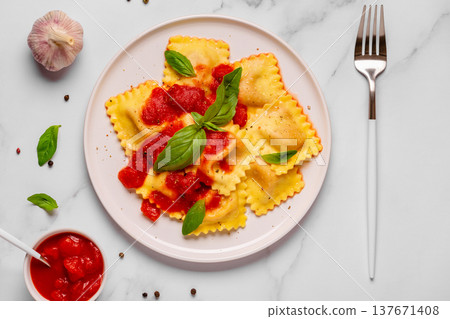 Delicious appetizing ravioli with tomato sauce and basil 137671408