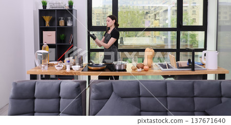 Cooking adventure in a modern kitchen with fresh ingredients and a creative spirit on a sunny day 137671640