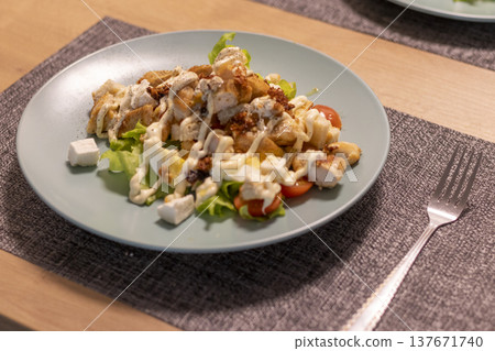 The dish pictured is a chicken Caesar salad The dish pictured is a chicken Caesar salad 137671740