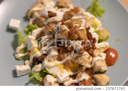 The dish pictured is a chicken Caesar salad The dish pictured is a chicken Caesar salad 137671741