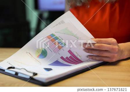 Detailed charts and graphs displayed in a report during a business meeting showcasing important data analysis insights 137671821