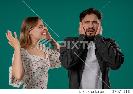 Grumpy Woman Quarrels On Husband Or Boyfriend On Green. Tired Man Shut His Ears 137671918