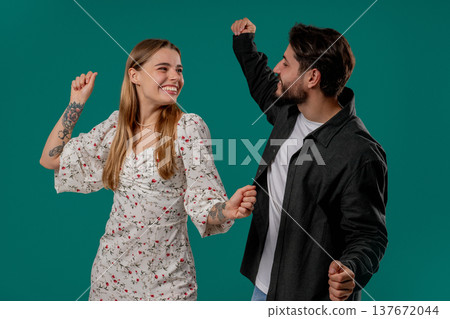 Positive Happy Young Couple Dancing. Green Studio Wall. Music, Dance, Party,love 137672044