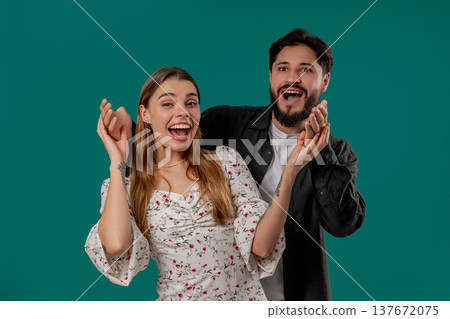 Handsome Man Surprising His Beloved Girlfriend. Happy Couple On Green Studio 137672075