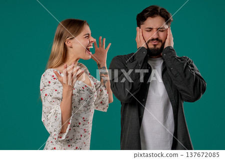 Grumpy Woman Quarrels On Husband Or Boyfriend On Green. Tired Man Shut His Ears Grumpy Woman Quarrels On Husband Or Boyfriend On Green. Tired Man Shut His Ears 137672085