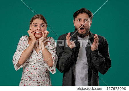 Shocked Young Couple Reacting Fear, Looking At Camera Studio. Unexpected News 137672098