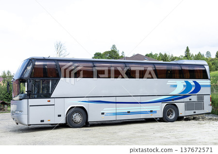 Grey passenger bus viewed from the side standing on a parking lot. Public transportation and travel concept Grey passenger bus viewed from the side standing on a parking lot. Public transportation and travel concept 137672571