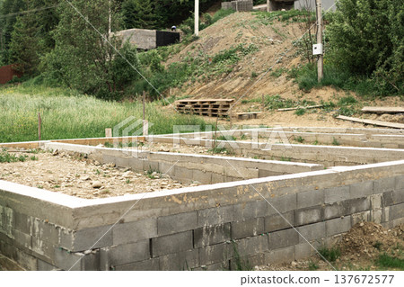 Groundwork and preparation for pouring house foundation at a residential construction site 137672577