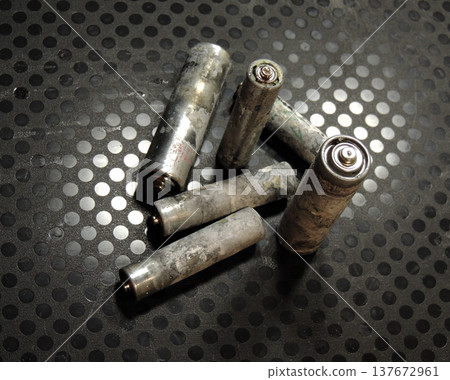 Old Corroded AA Batteries on Textured Surface. Corroded AAA batteries close up stock photo Old Corroded AA Batteries on Textured Surface. Corroded AAA batteries close up stock photo 137672961